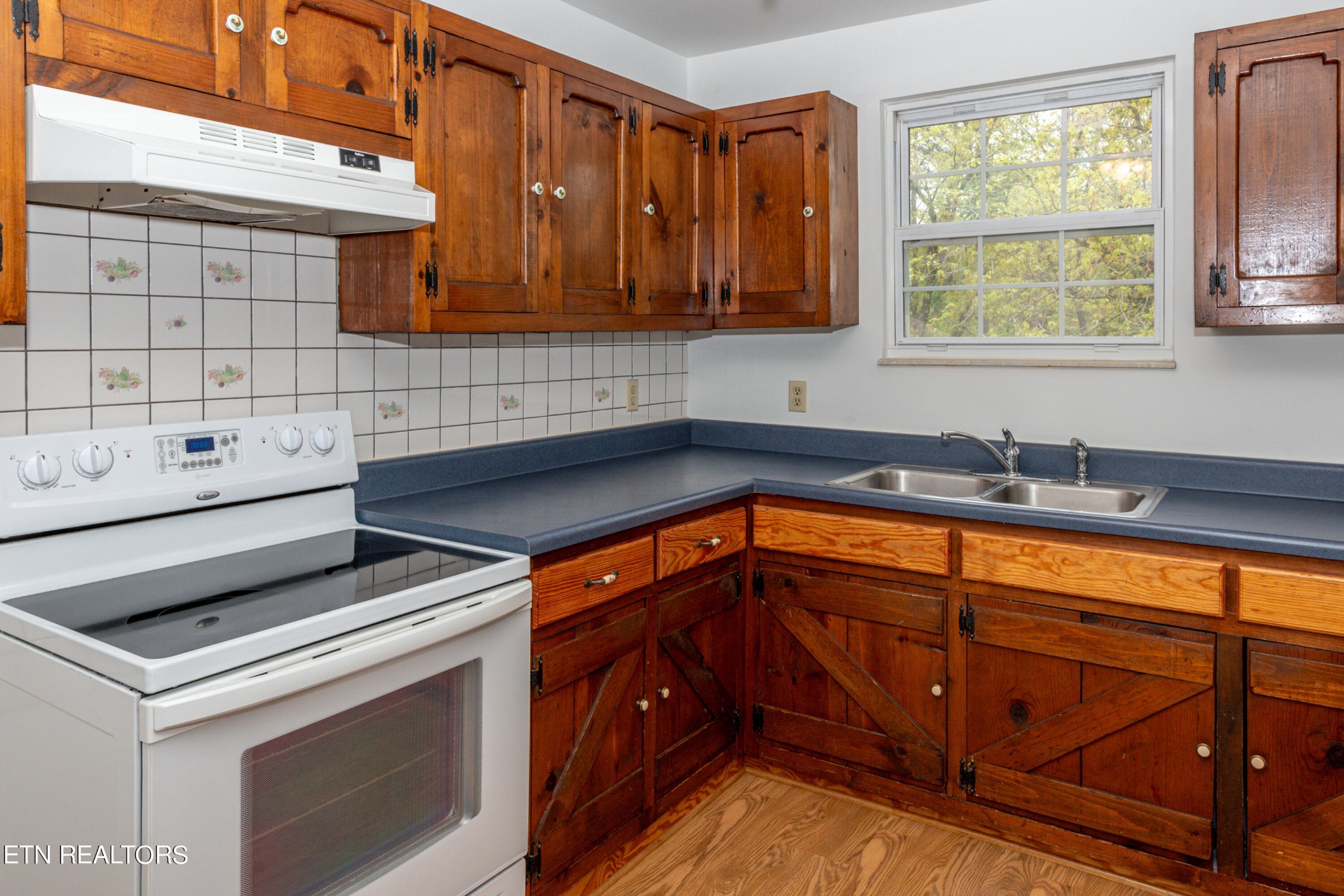4038 Big Springs Ridge Road Friendsville, TN 37737 - Photo 10 of 26 a kitchen with granite countertop cabinets sink and window