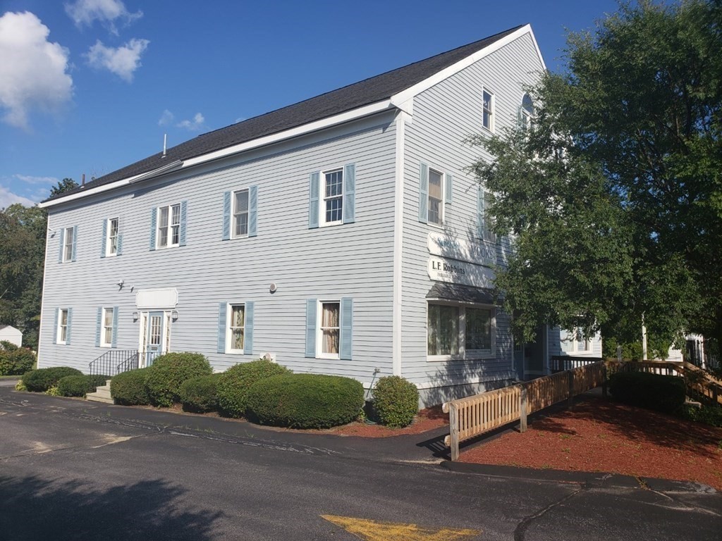 241 Main Street, Unit 23 Townsend, MA 01469 - Photo 1 of 1 a front view of a house with a tree