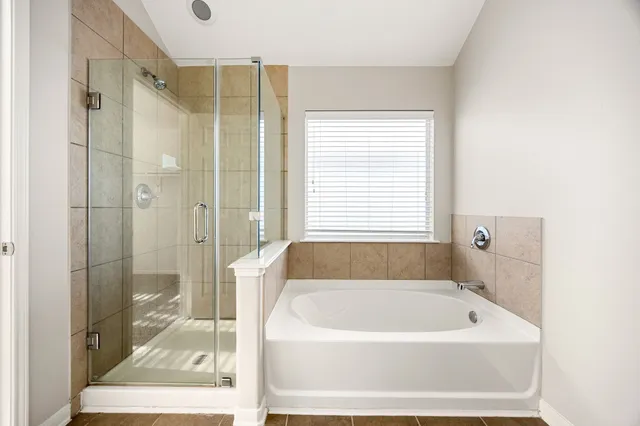 a bathroom with a bathtub and a shower