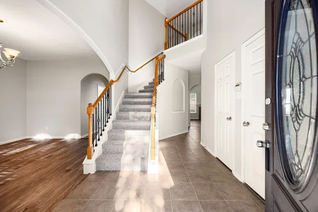 a view of entryway and hall with wooden floor