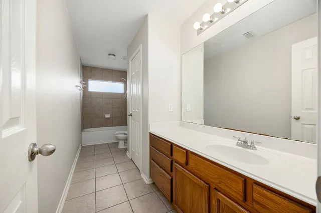 a spacious bathroom with a shower sink and mirror