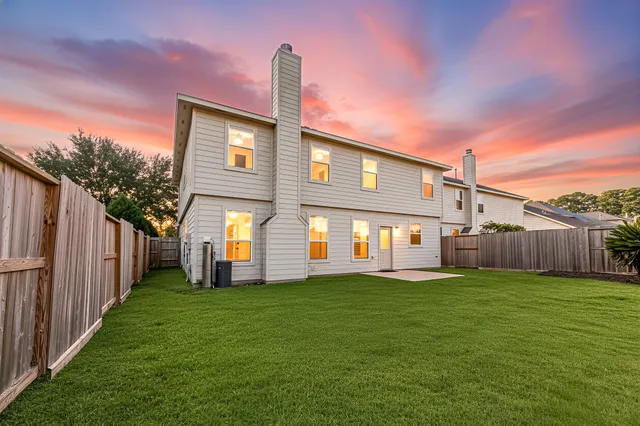 a view of a house with a yard and pathway