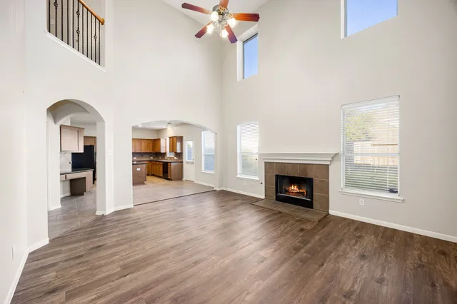 a view of a livingroom with a fireplace wooden floor and a window