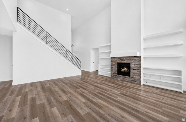 1002 West Temple Rim Lane Payson, UT 84651 - Photo 11 of 68 Spacious living area featuring high vaulted ceilings, wood-finish flooring, and a contemporary fireplace with a stone surround