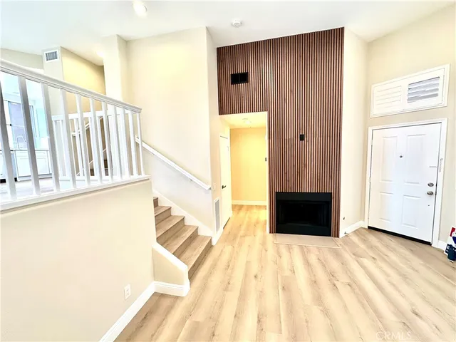 a view of a bedroom with wooden floor and a bathroom