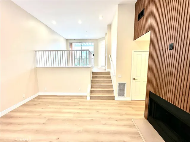 a view of a hallway with wooden floor and entryway