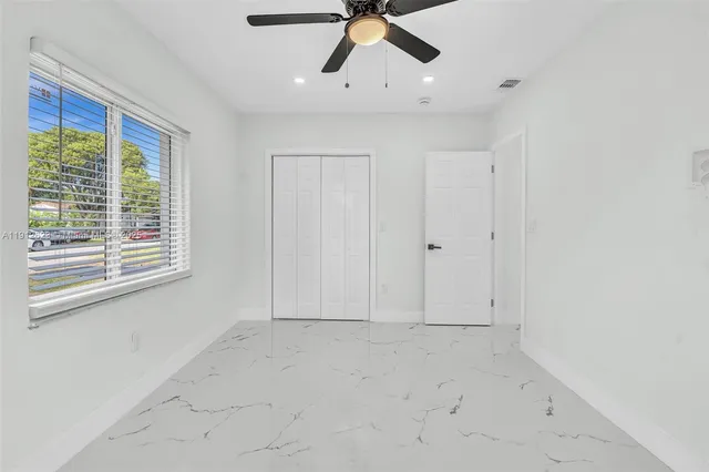 a view of empty room with ceiling fan