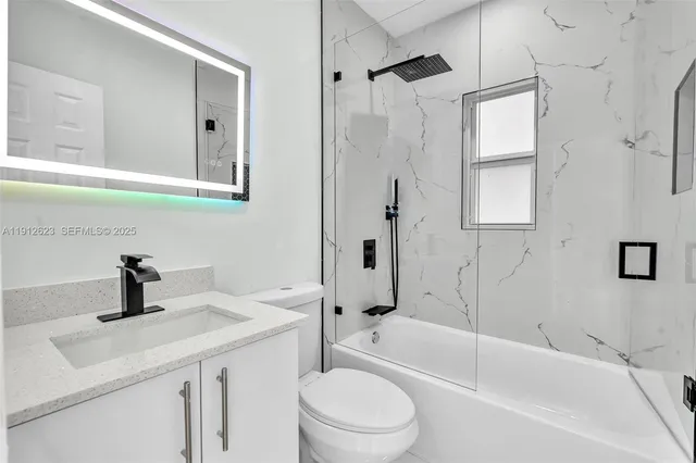 a bathroom with a sink a toilet and a bathtub