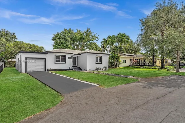 a front view of house with yard and green space