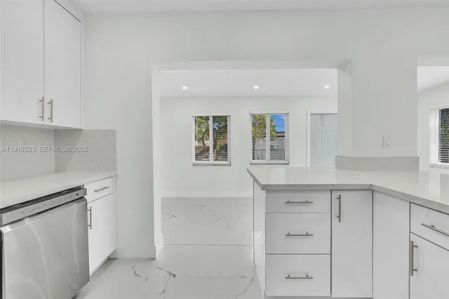 a kitchen with white cabinets and a sink