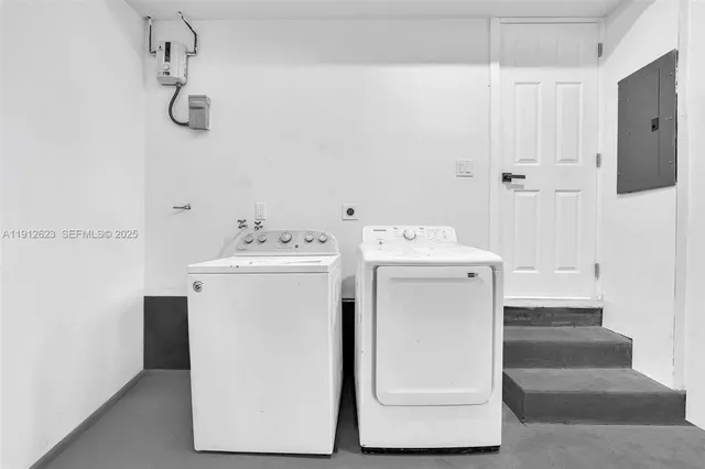 a utility room with cabinets washer and dryer