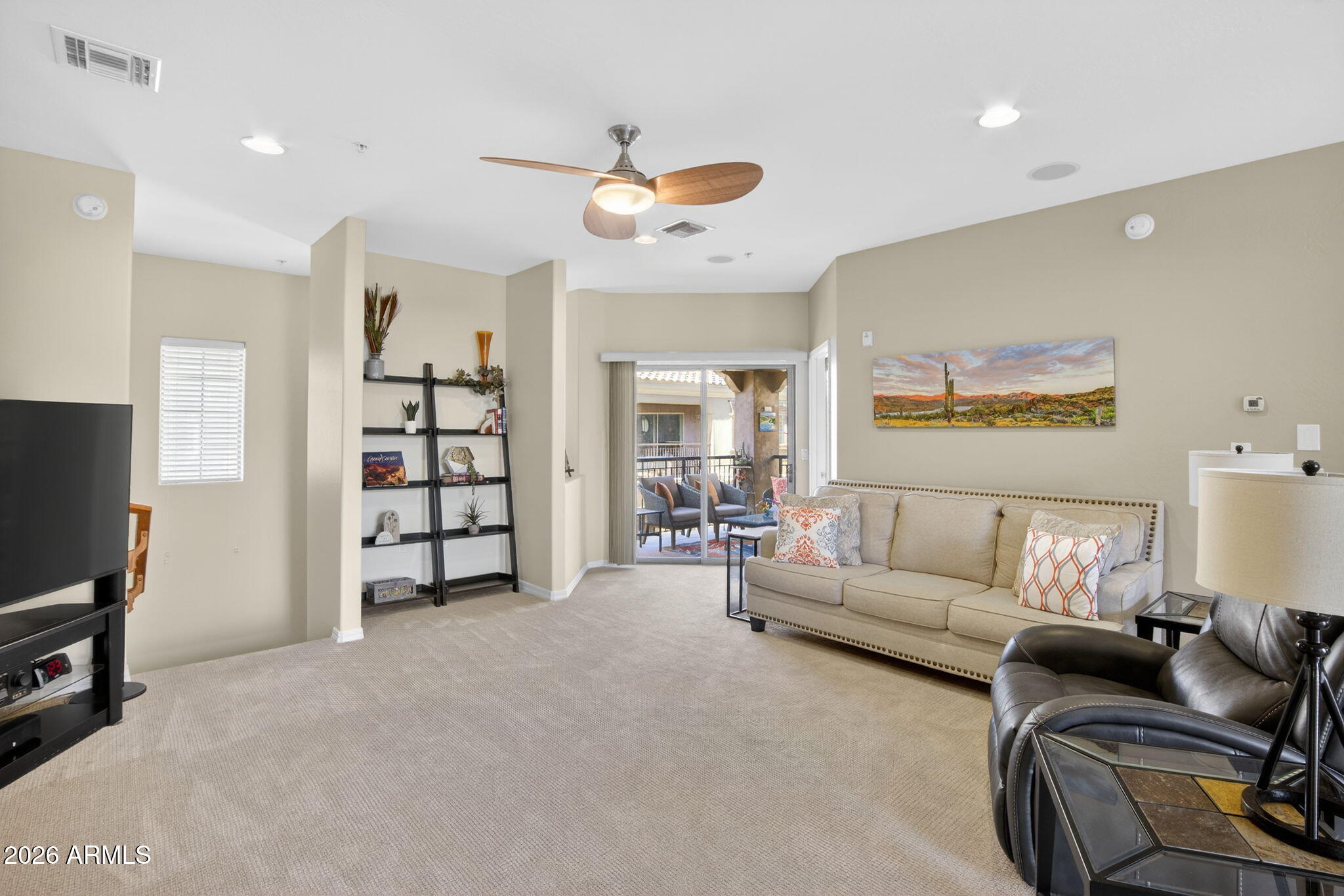 3935 East Rough Rider Road, Unit 1145 Phoenix, AZ 85050 - Photo 10 of 32 a living room with furniture and a flat screen tv