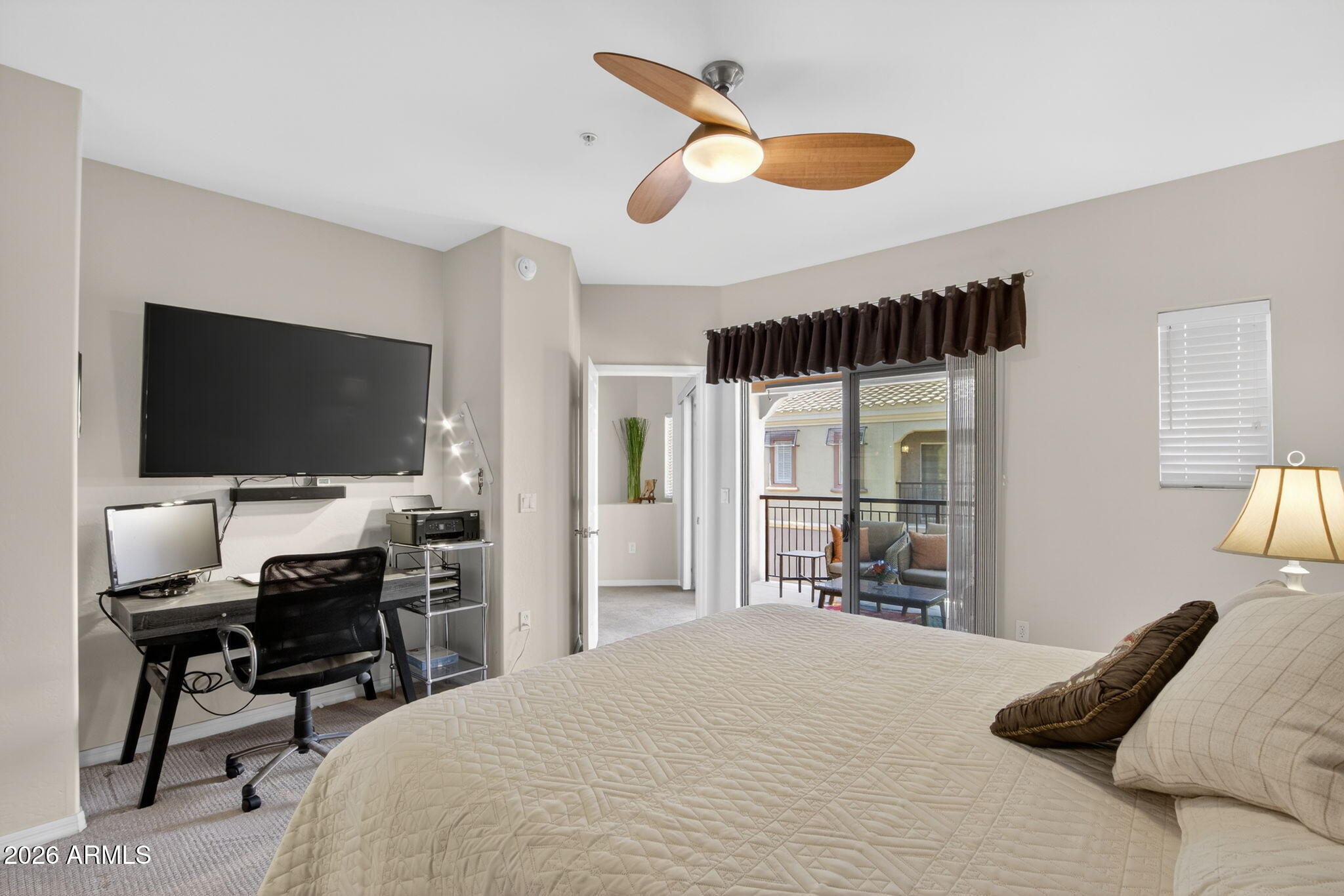 3935 East Rough Rider Road, Unit 1145 Phoenix, AZ 85050 - Photo 13 of 32 a bedroom with a bed and a flat screen tv