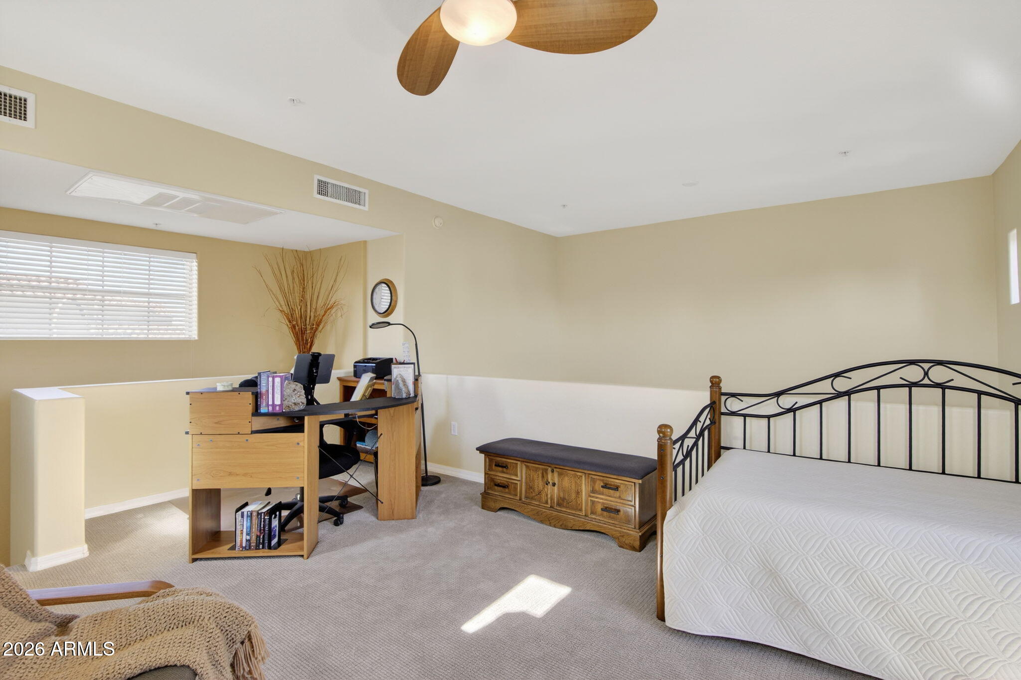 3935 East Rough Rider Road, Unit 1145 Phoenix, AZ 85050 - Photo 18 of 32 a bedroom with furniture and a window