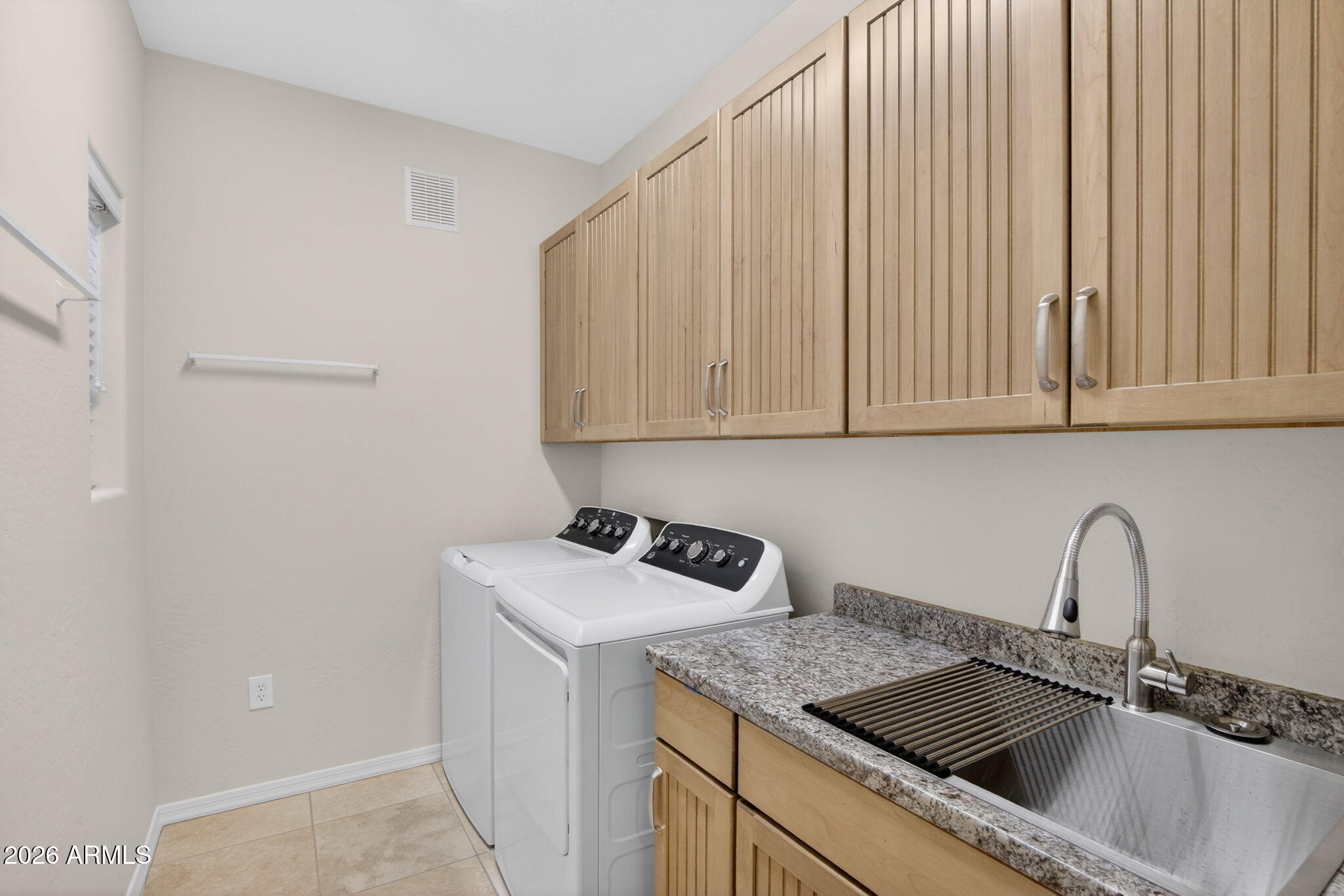 3935 East Rough Rider Road, Unit 1145 Phoenix, AZ 85050 - Photo 20 of 32 a kitchen with stainless steel appliances granite countertop a sink and a white cabinets