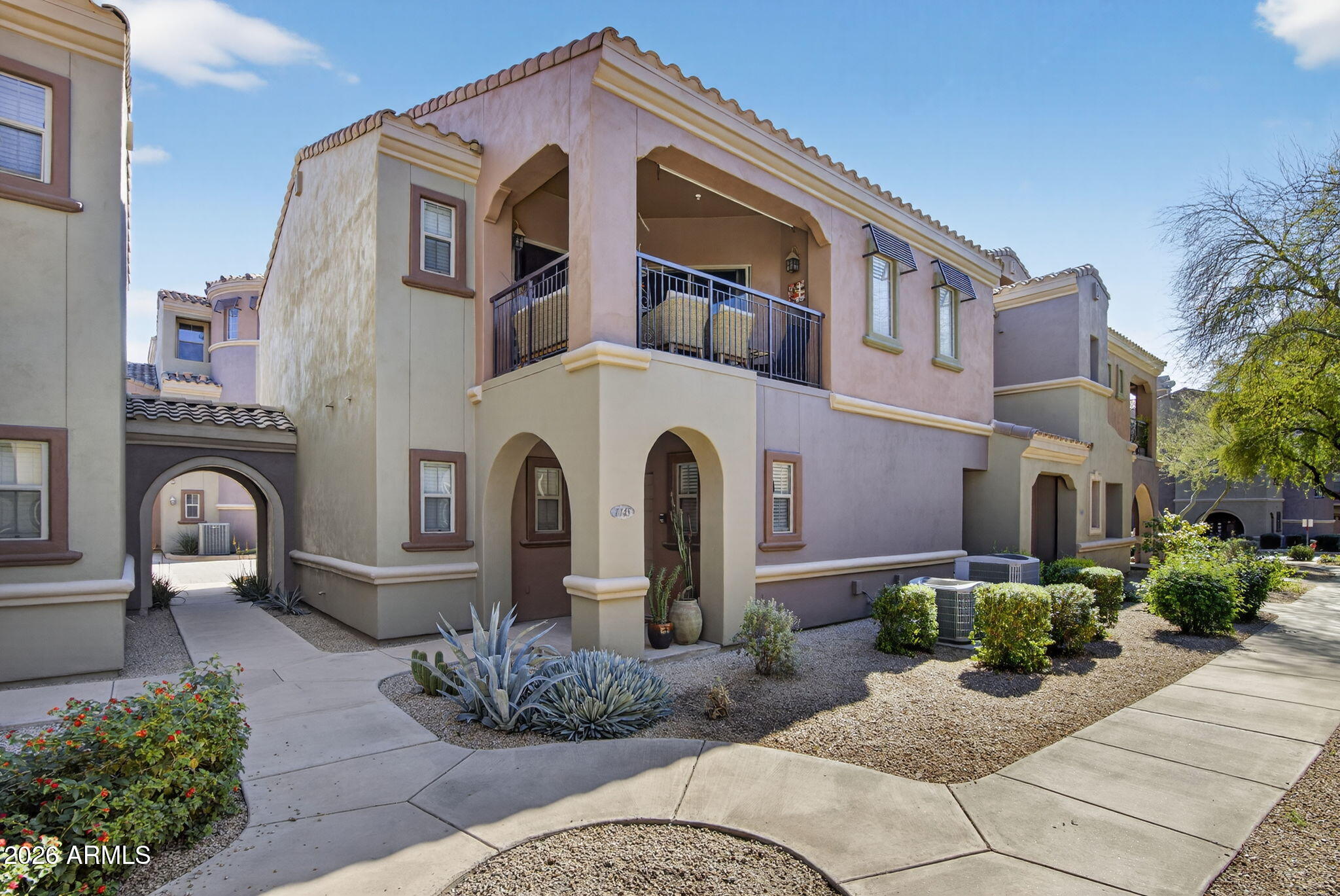 3935 East Rough Rider Road, Unit 1145 Phoenix, AZ 85050 - Photo 24 of 32 a front view of a house with garden