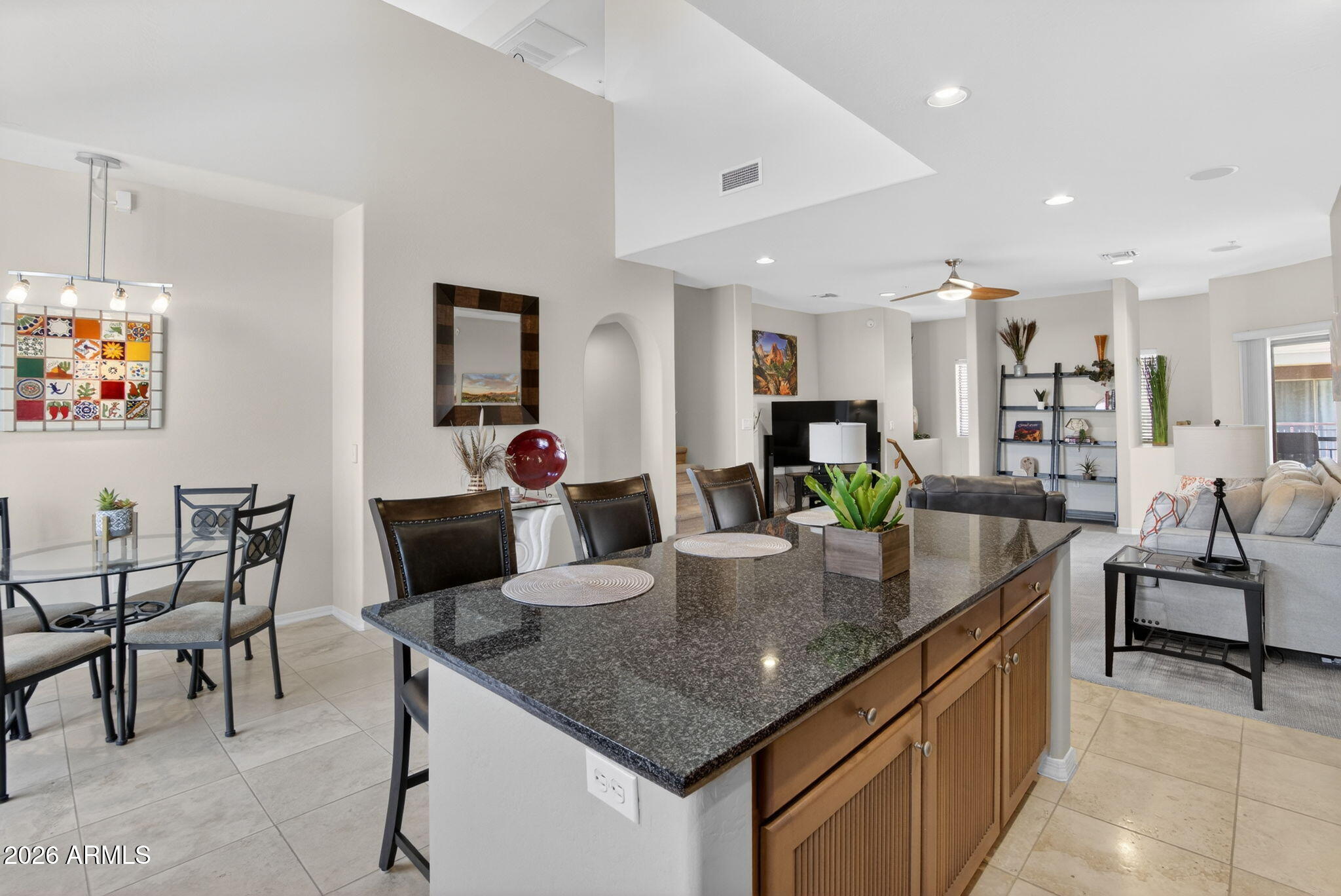 3935 East Rough Rider Road, Unit 1145 Phoenix, AZ 85050 - Photo 5 of 32 a kitchen with center island table and chairs in it