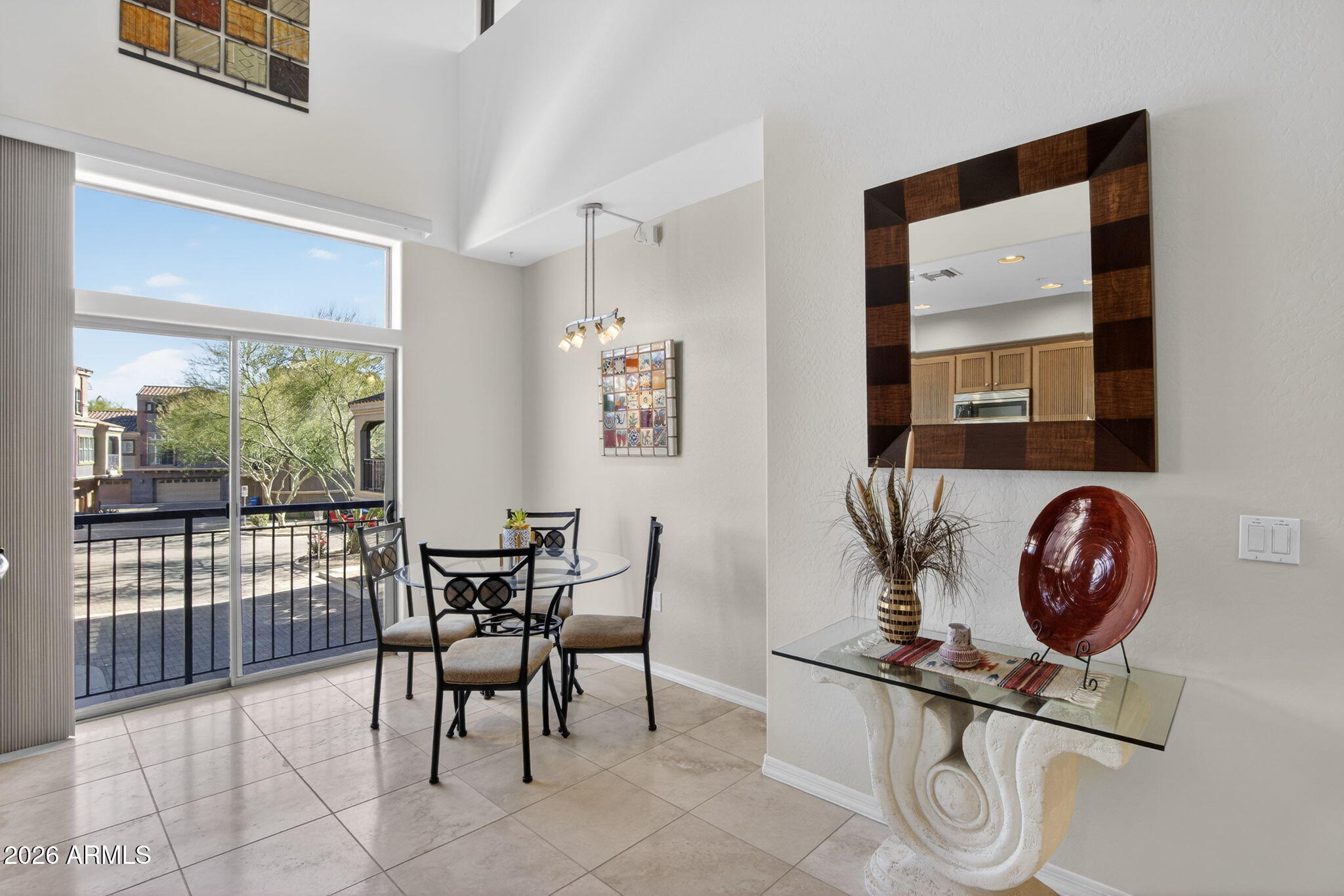 3935 East Rough Rider Road, Unit 1145 Phoenix, AZ 85050 - Photo 7 of 32 a view of a dining room with furniture and chandelier
