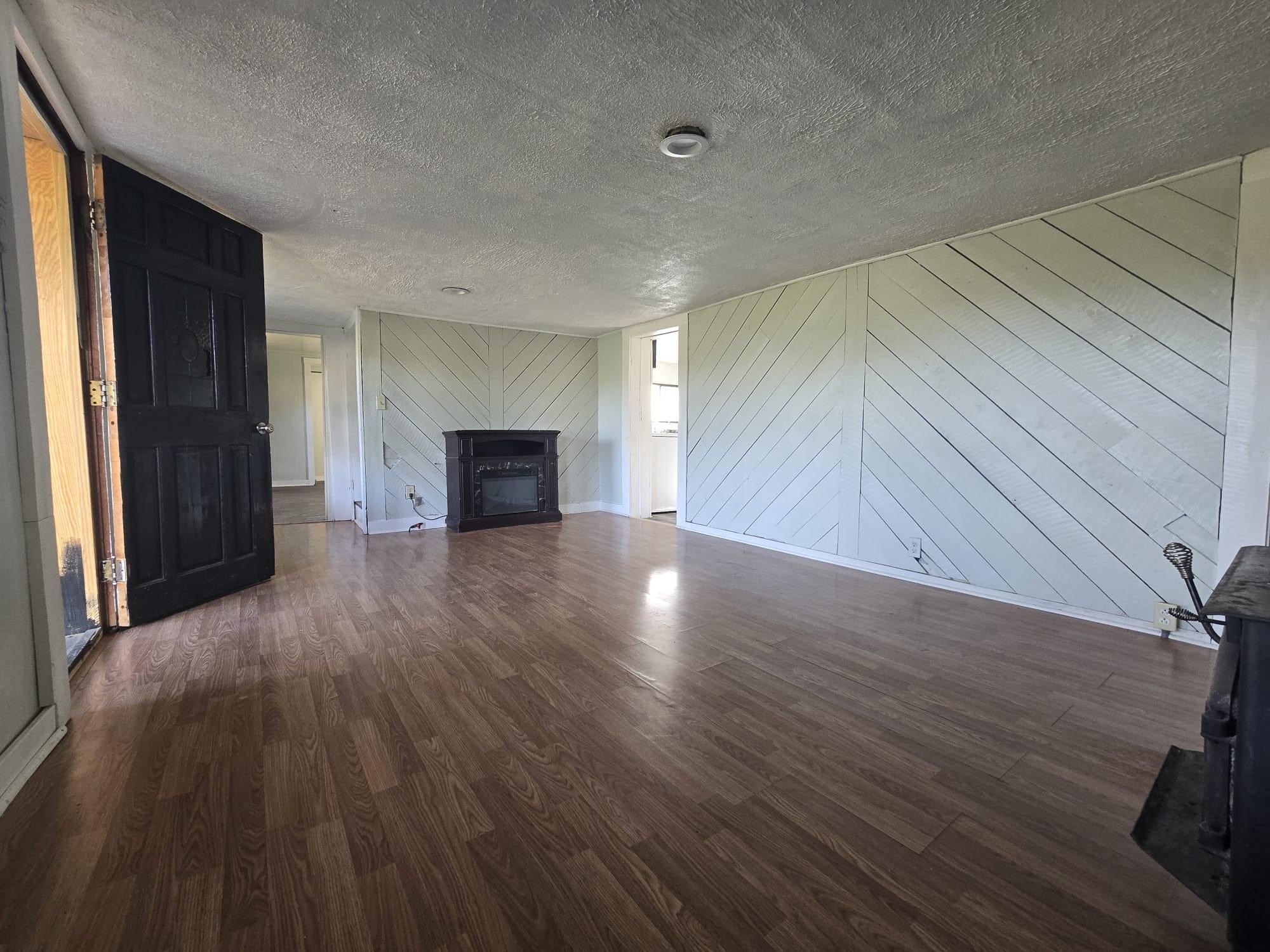 1596 Volunteer Road Rutledge, TN 37861 - Photo 2 of 25 an empty room with wooden floor fireplace and windows