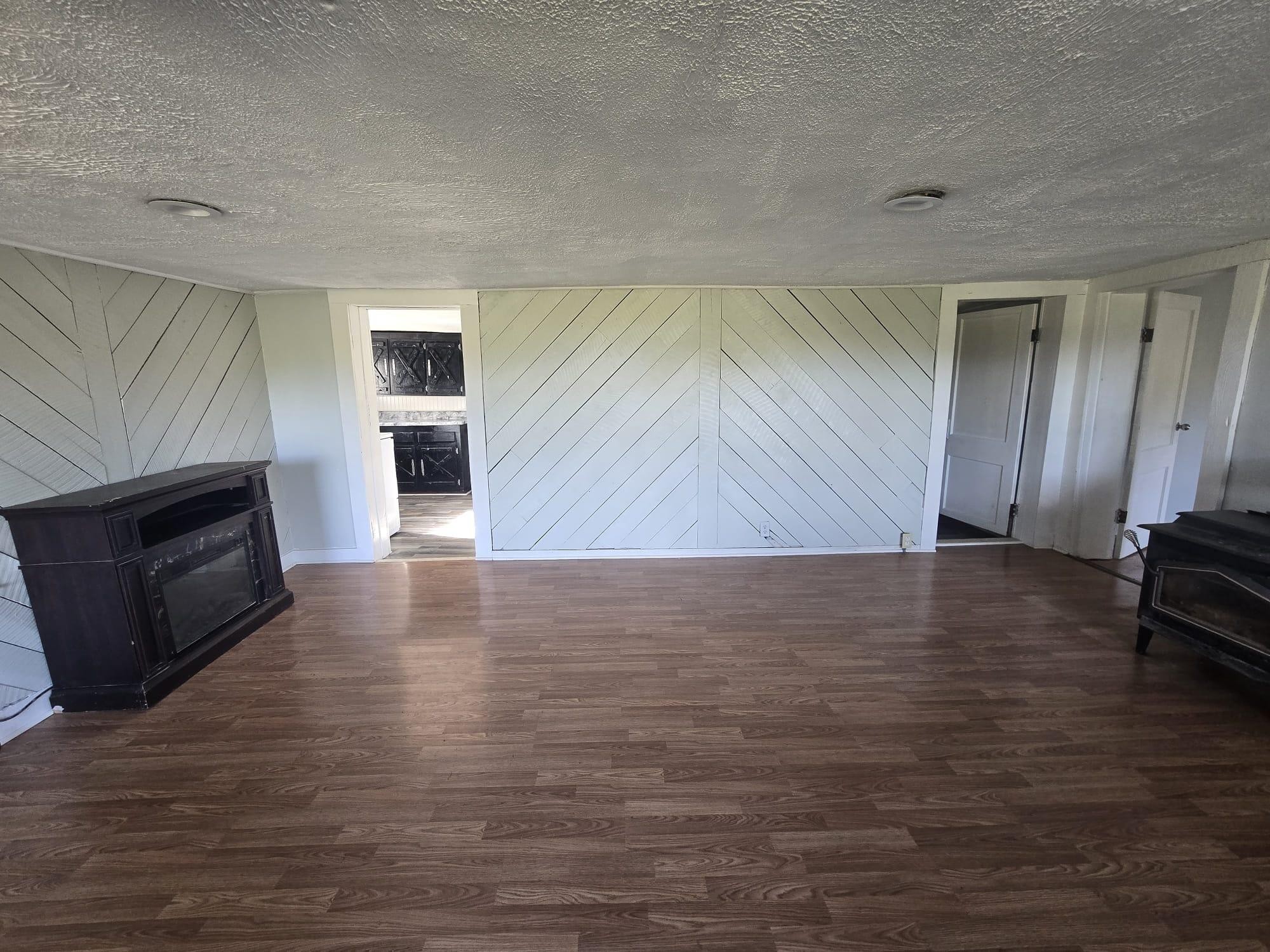 1596 Volunteer Road Rutledge, TN 37861 - Photo 3 of 25 a view of a livingroom with furniture a fireplace and wooden floor