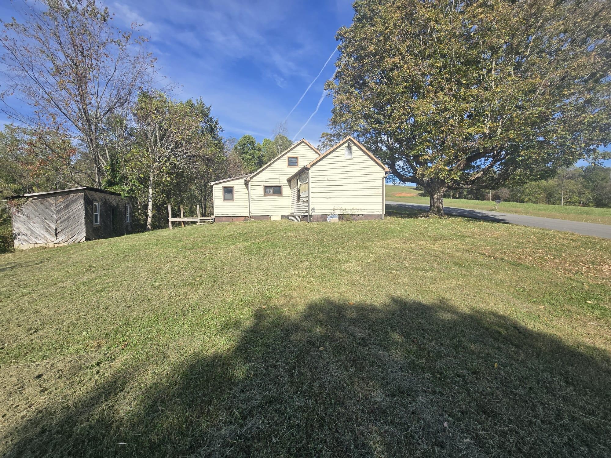 1596 Volunteer Road Rutledge, TN 37861 - Photo 9 of 25 a large house with a big yard and large trees