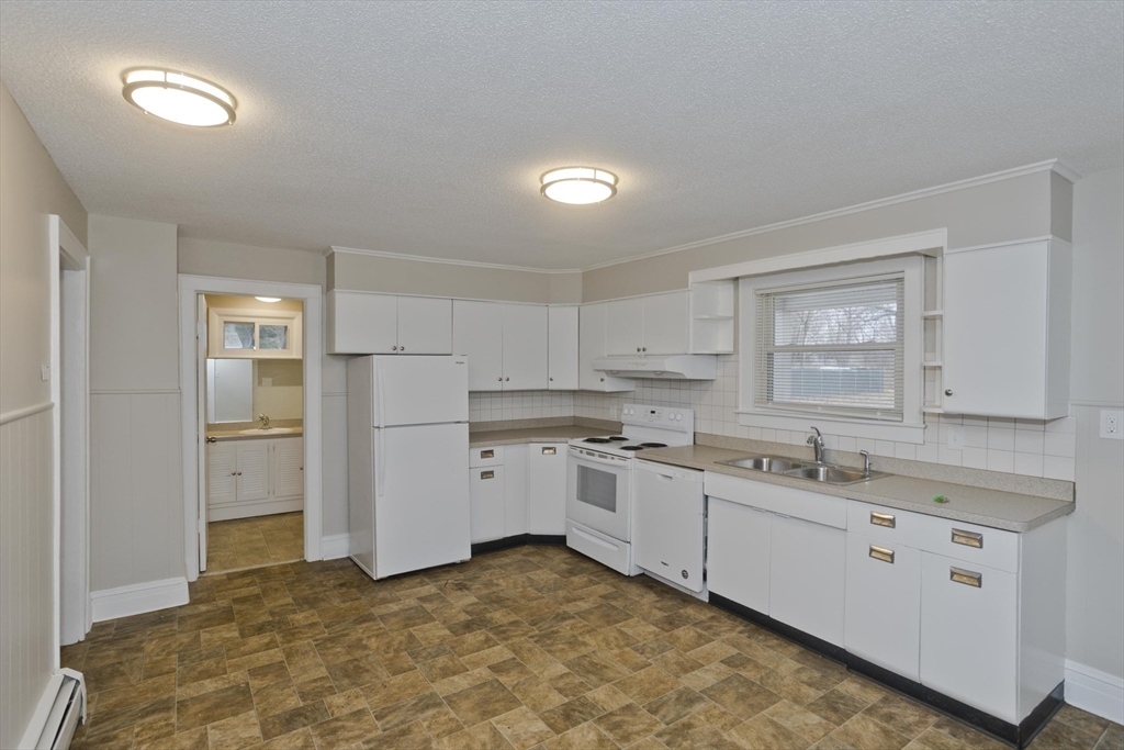 177 Marion Street Chicopee, MA 01013 - Photo 10 of 36 a kitchen with a sink stove and cabinets