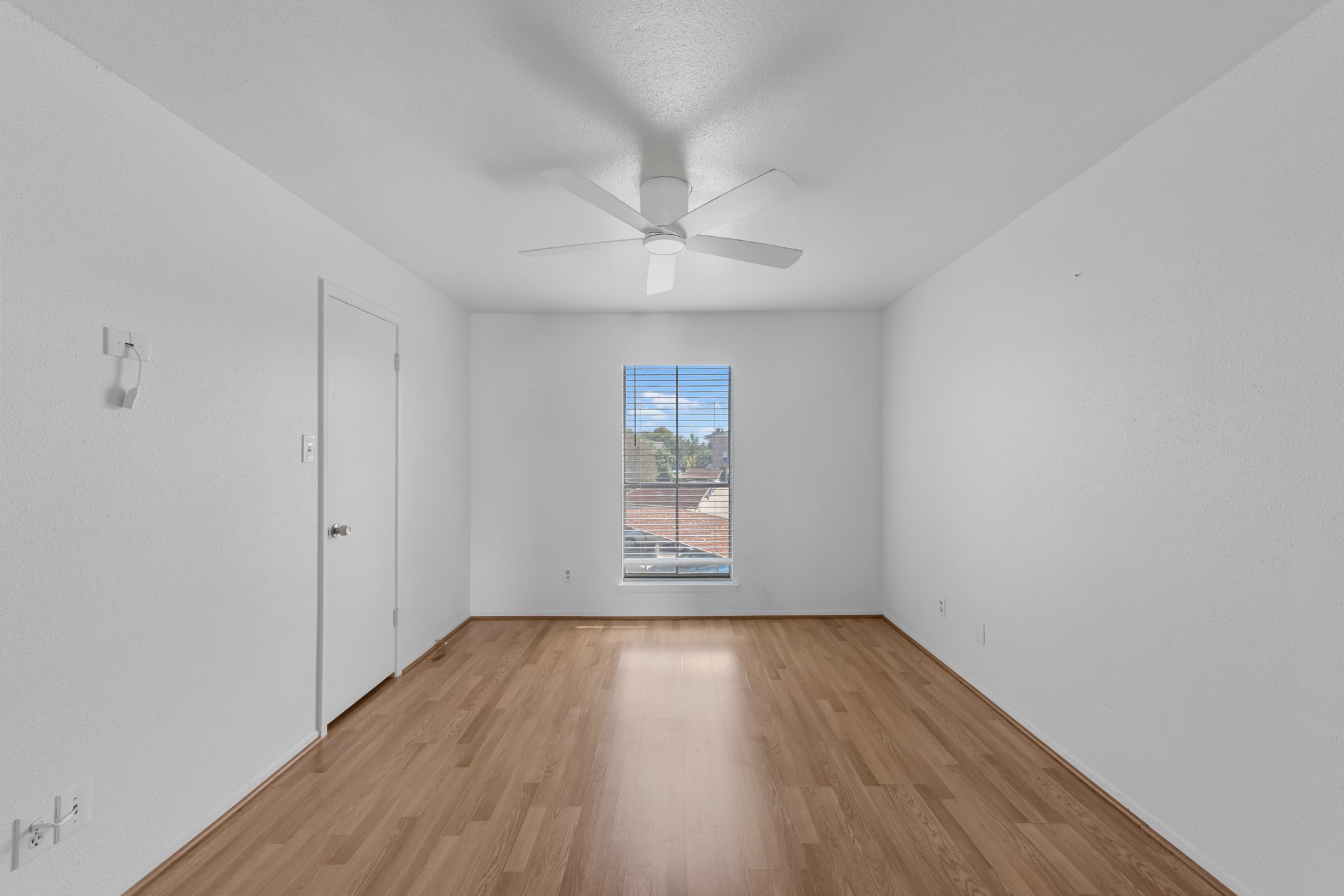 18800 Egret Bay Boulevard, Unit 804 Webster, TX 77058 - Photo 14 of 29 wooden floor in an empty room with a window