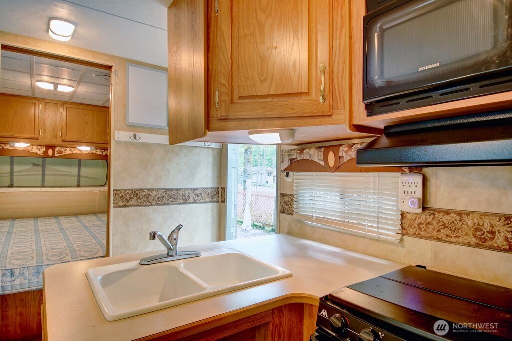 61 Christmas Tree Circle Maple Falls, WA 98266 - Photo 10 of 34 a kitchen with a sink and a stove top oven