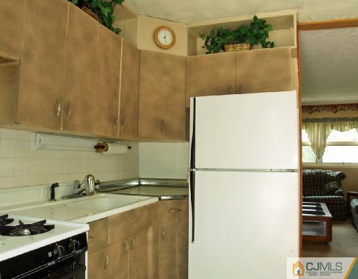 51 Ashley Road Edison, NJ 08817 - Photo 3 of 10 a white refrigerator freezer sitting inside of a kitchen
