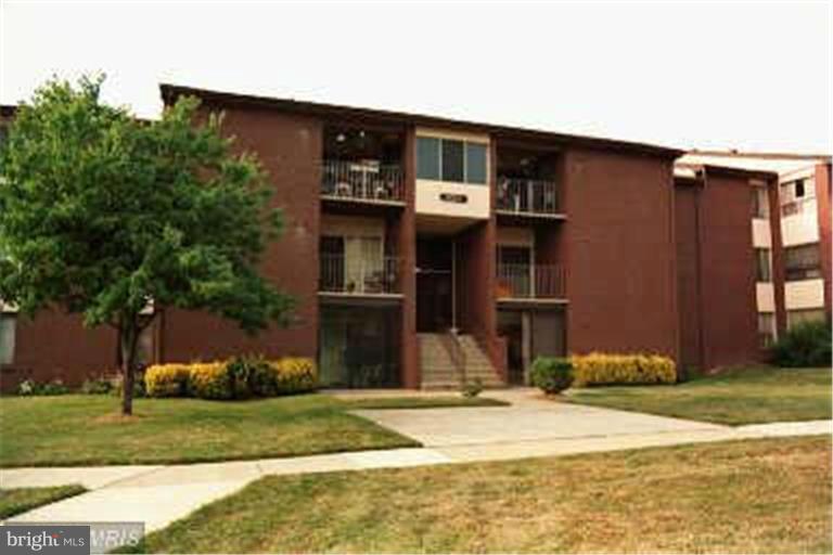 8003 Mandan Road, Unit T3 Greenbelt, MD 20770 - Photo 1 of 1 a front view of a house with a yard