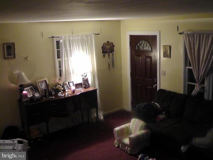 12106 Goodhill Road Silver Spring, MD 20902 - Photo 15 of 18 a living room with furniture and a chandelier