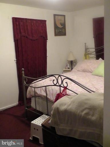 12106 Goodhill Road Silver Spring, MD 20902 - Photo 4 of 18 a bedroom with a bed and wooden floor