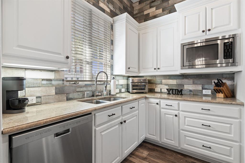 8444 Library Street Frisco, TX 75034 - Photo 13 of 36 a kitchen with stainless steel appliances granite countertop white cabinets a sink and dishwasher