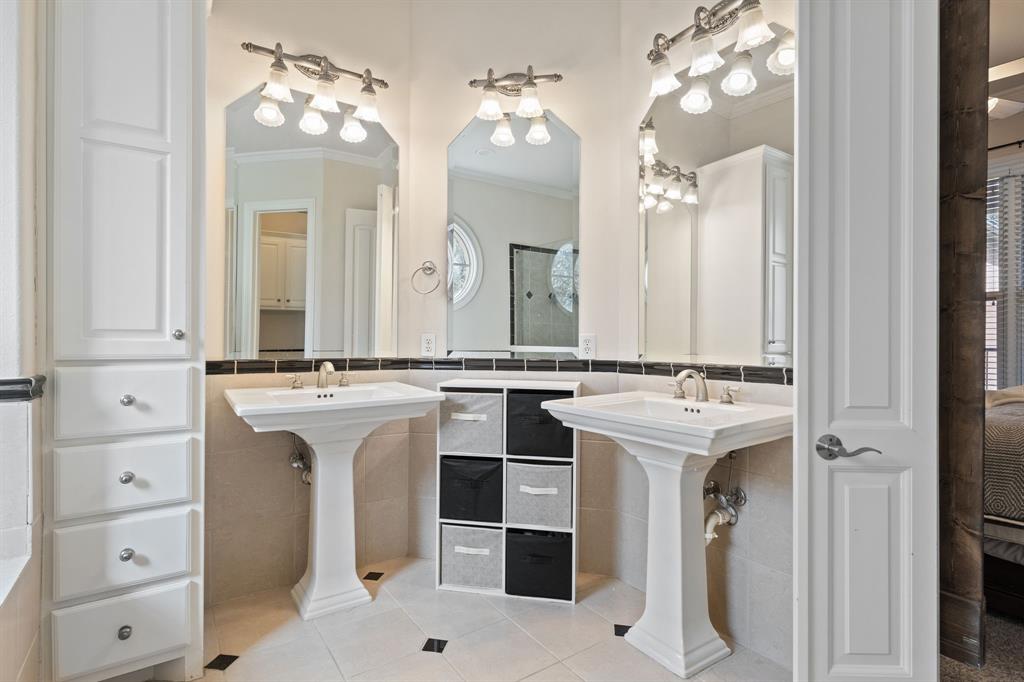 8444 Library Street Frisco, TX 75034 - Photo 19 of 36 a bathroom with a sink and a mirror