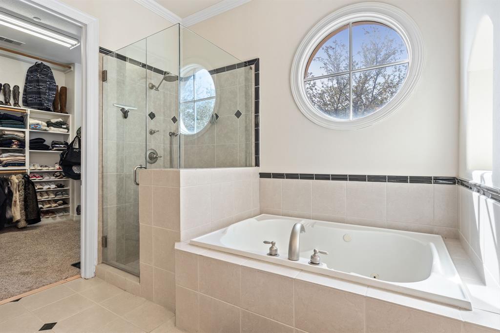 8444 Library Street Frisco, TX 75034 - Photo 20 of 36 a bathroom with a tub a shower and a sink