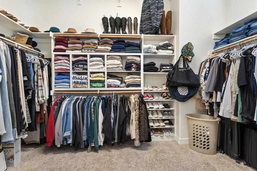 8444 Library Street Frisco, TX 75034 - Photo 21 of 36 a view of walk in closet with clothes and shoes