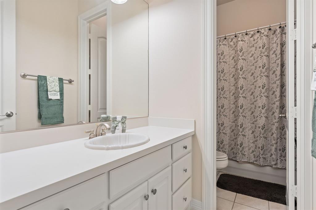 8444 Library Street Frisco, TX 75034 - Photo 24 of 36 a bathroom with a sink and a mirror