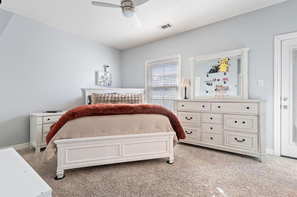 8444 Library Street Frisco, TX 75034 - Photo 25 of 36 a bedroom with a bed and a cabinets
