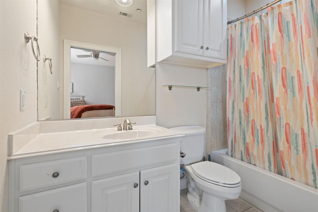 8444 Library Street Frisco, TX 75034 - Photo 26 of 36 a bathroom with a sink a toilet and a mirror
