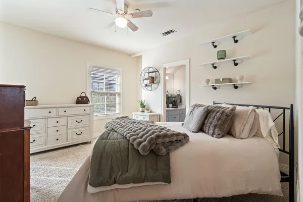 a bedroom with a bed and a dresser