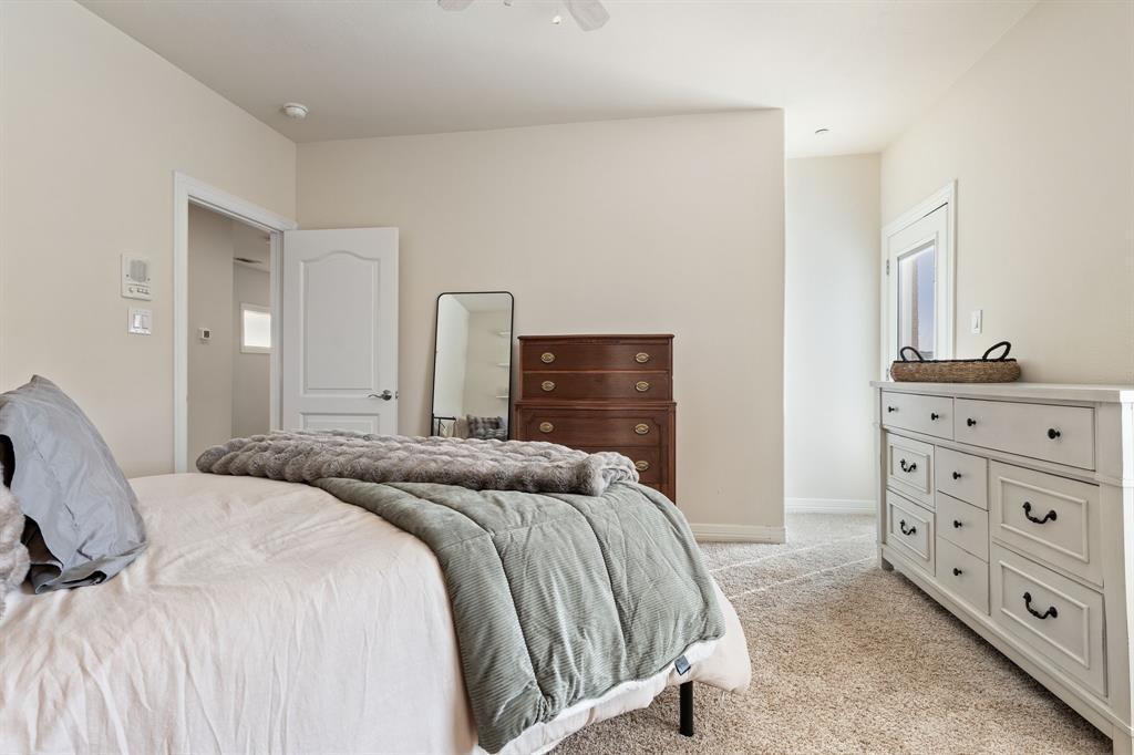 8444 Library Street Frisco, TX 75034 - Photo 28 of 36 a bedroom with a bed and a dresser