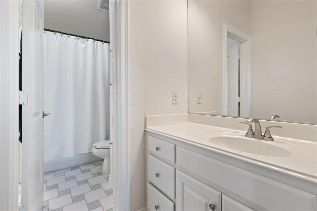 8444 Library Street Frisco, TX 75034 - Photo 31 of 36 a bathroom with a sink toilet and shower