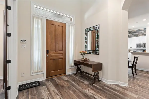 a view of hall way with furniture and wooden floor