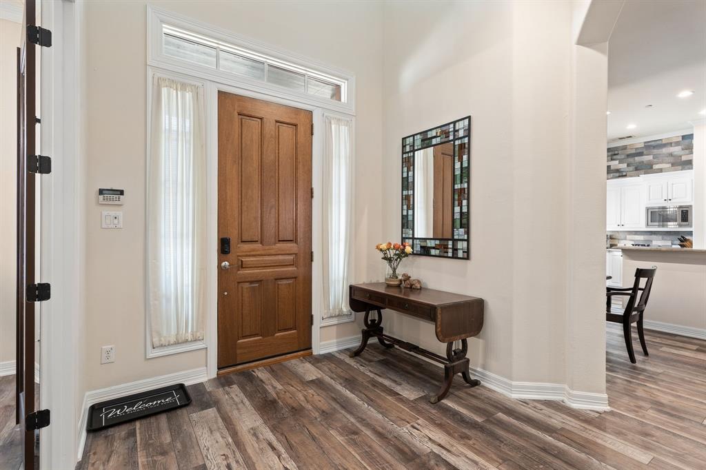 8444 Library Street Frisco, TX 75034 - Photo 5 of 36 a view of a hallway with wooden floor and a bathroom