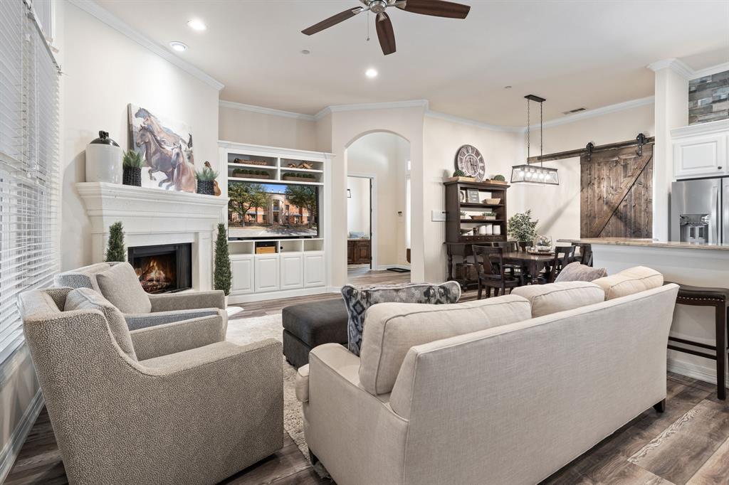 8444 Library Street Frisco, TX 75034 - Photo 8 of 36 a living room with furniture and a fireplace