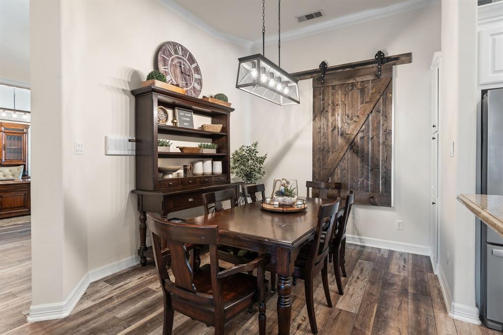 8444 Library Street Frisco, TX 75034 - Photo 10 of 36 a view of a dining room that has a table and chairs