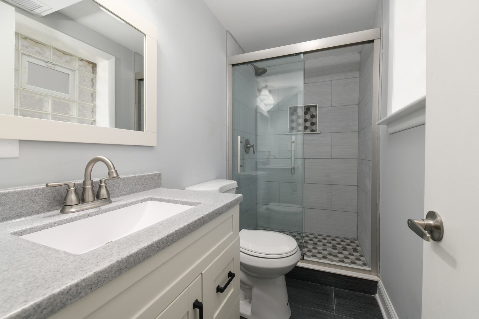 44 Redwood Trail Wheeling, IL 60090 - Photo 14 of 18 a bathroom with a sink a toilet and shower