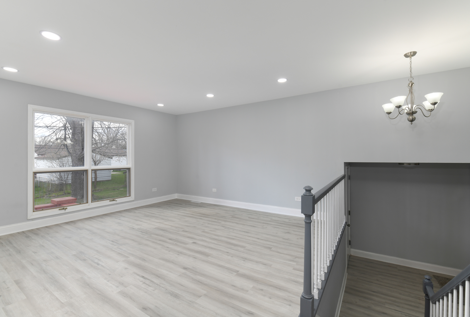 44 Redwood Trail Wheeling, IL 60090 - Photo 3 of 18 a view of a room with wooden floor and chandelier