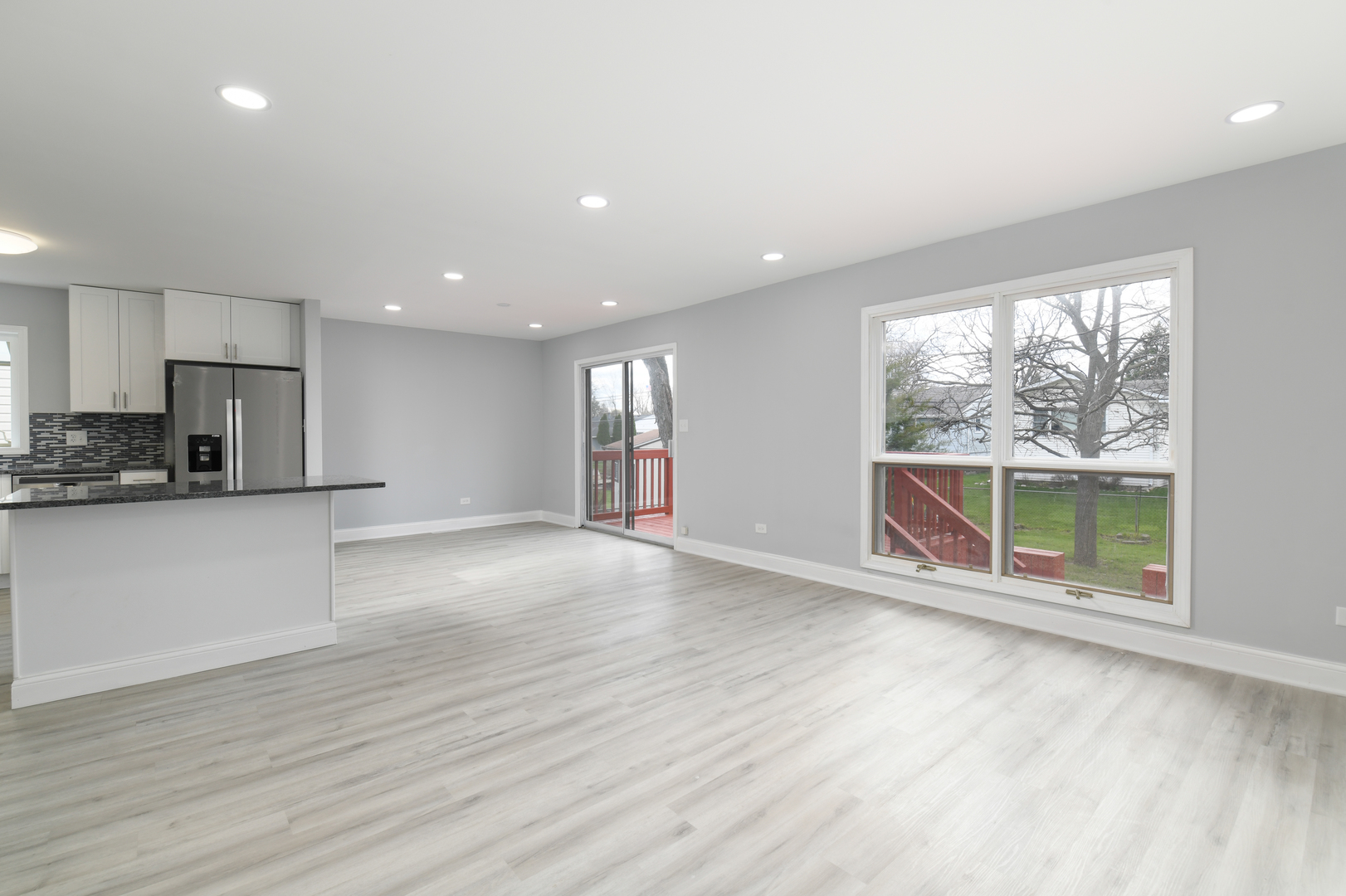 44 Redwood Trail Wheeling, IL 60090 - Photo 4 of 18 a view of an empty room with a window and wooden floor