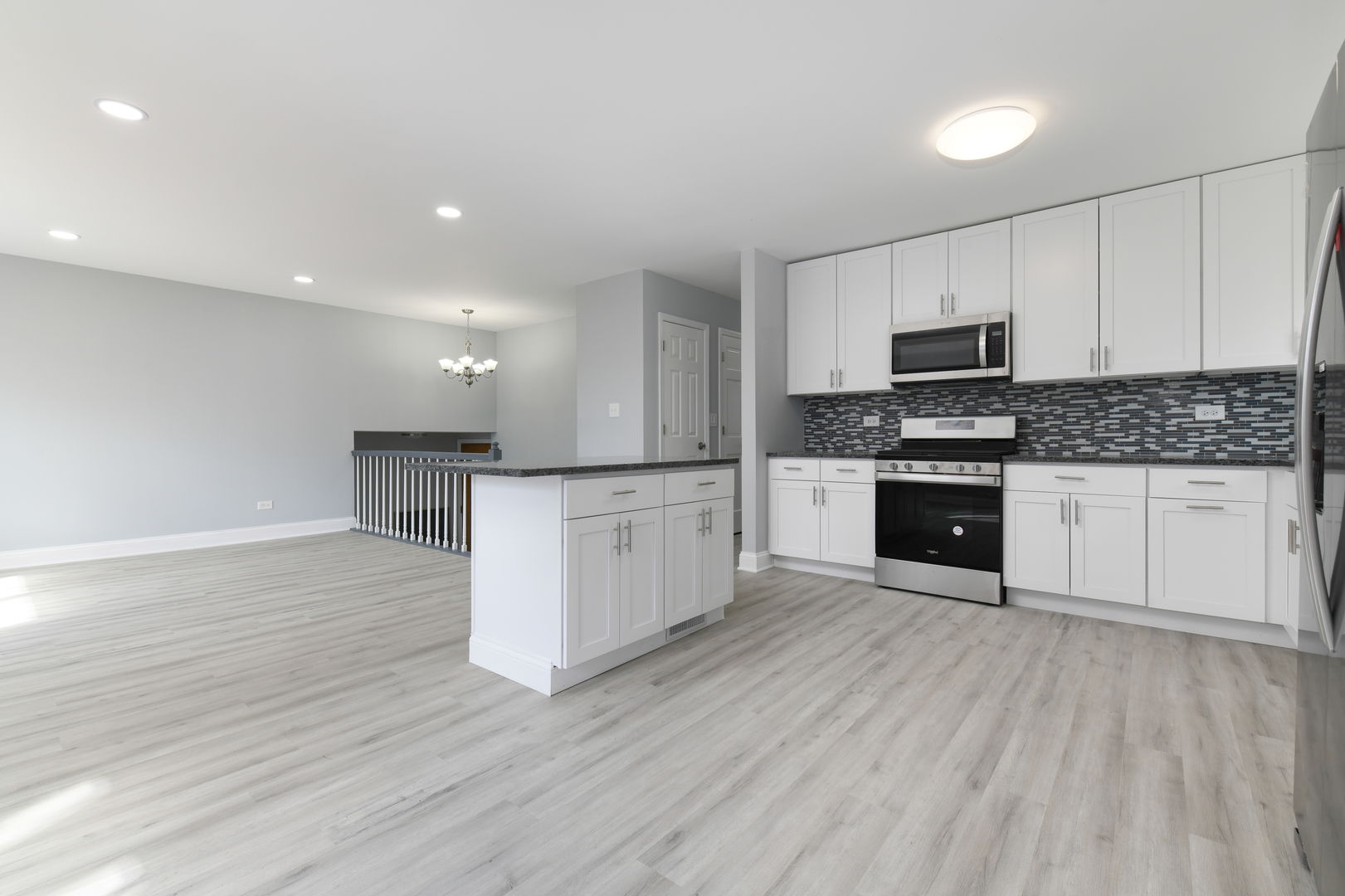 44 Redwood Trail Wheeling, IL 60090 - Photo 7 of 18 a large kitchen with cabinets wooden floor and stainless steel appliances